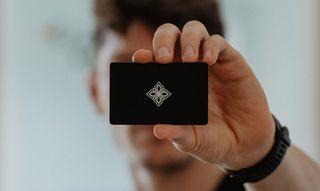 Man holding the Bloom card on blurry background