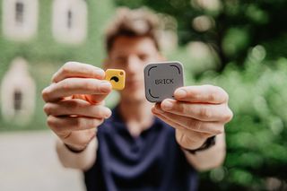 Man holding both Brick and Unpluq