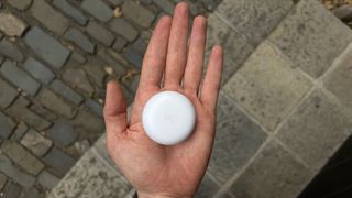 The halo held in an adult hand showing the size of the device