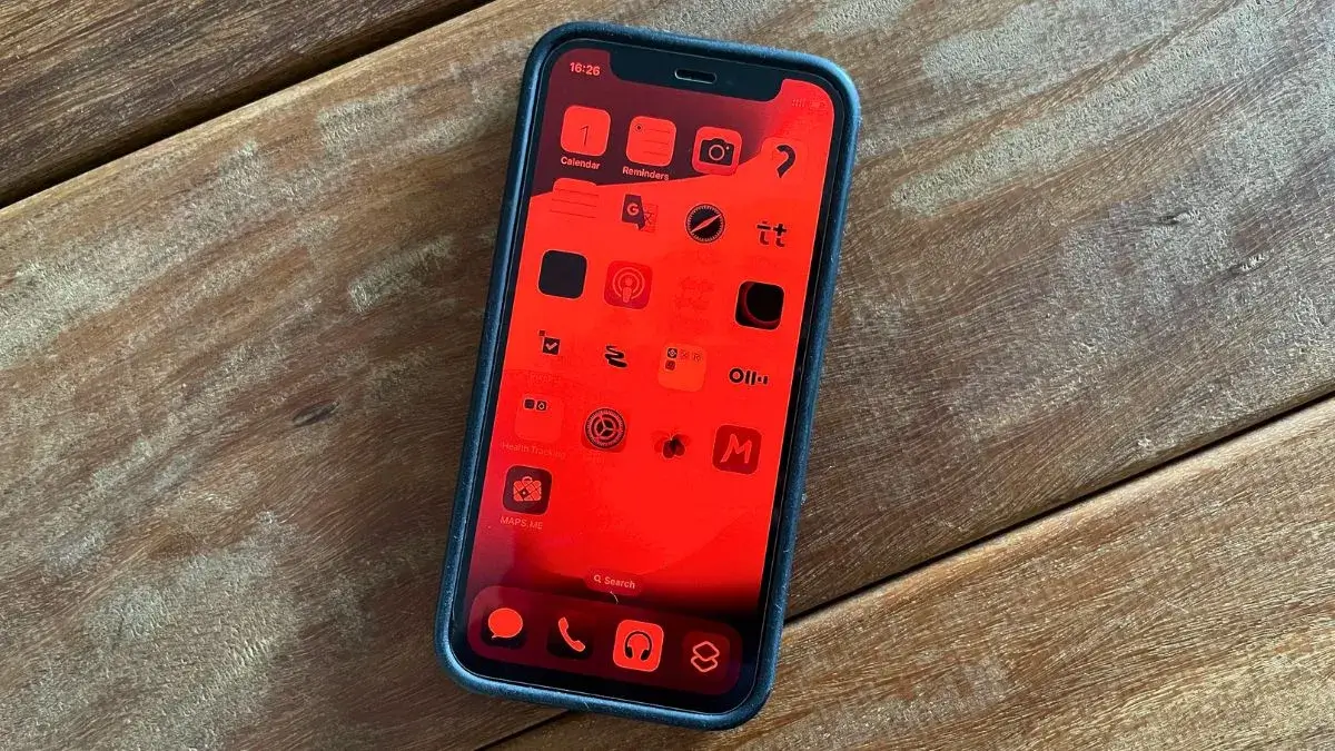 Red screen iPhone on wooden table
