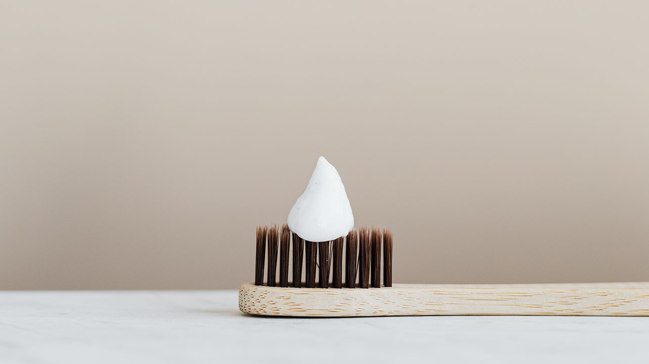 a toothbrush during a minimalist morning routine